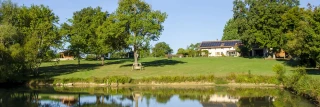 View of the gîte Le Benouchon from behind the pond
