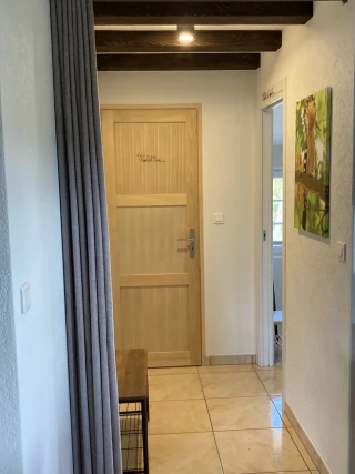 Hallway with open wardrobe in the gîte Le Benouchon
